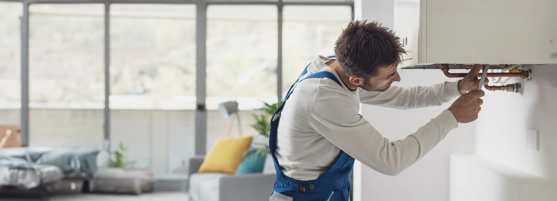 A heating engineer working on a domestic boiler
